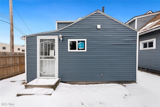 view of snow covered rear of property