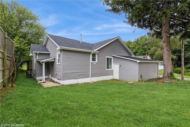 rear view of house with a yard