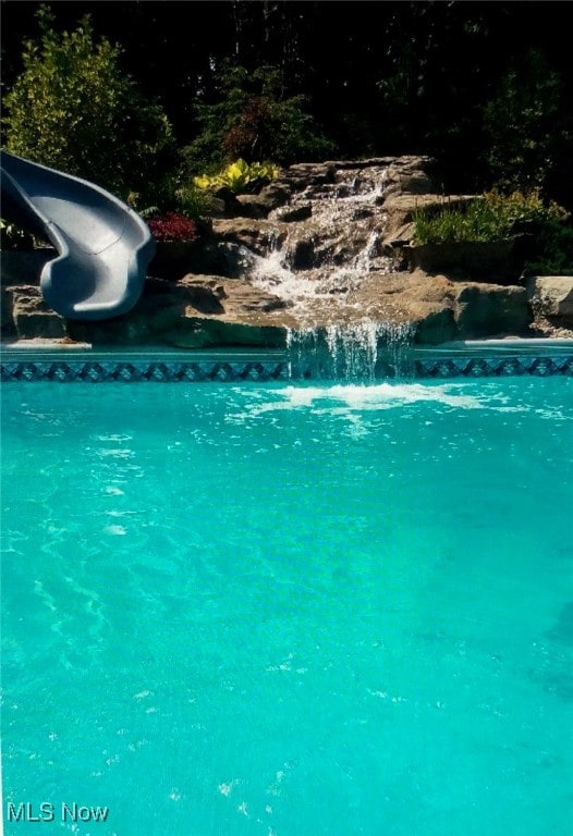 view of pool with a water slide