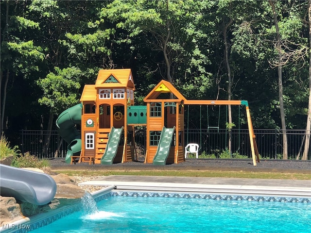 view of pool with a playground and a water slide