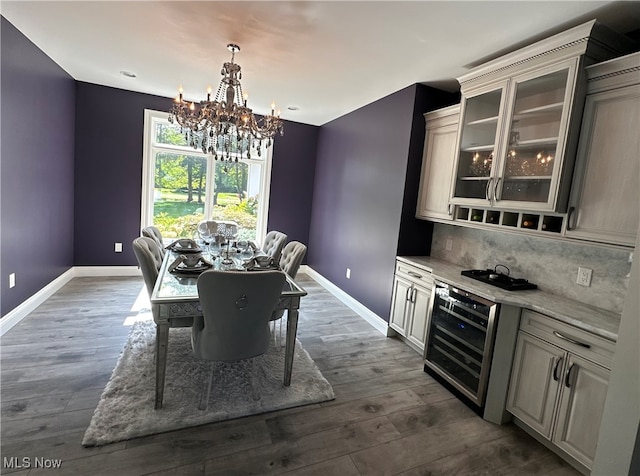 dining area with dark hardwood / wood-style floors, wine cooler, and a notable chandelier