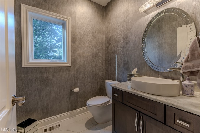 bathroom featuring vanity and toilet