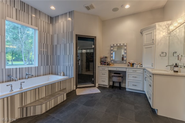 bathroom with vanity, tile walls, separate shower and tub, and tile patterned floors