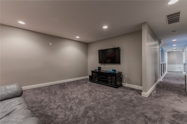 unfurnished living room with dark colored carpet