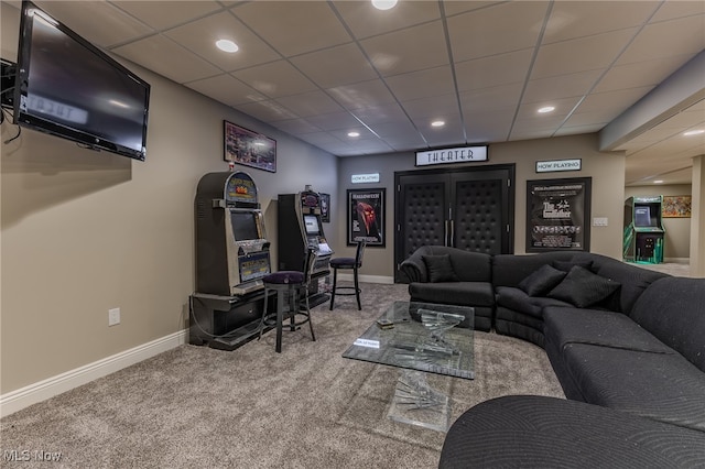 living room featuring a drop ceiling and carpet floors