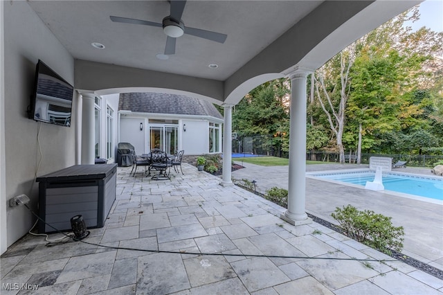 view of patio featuring ceiling fan and a fenced in pool