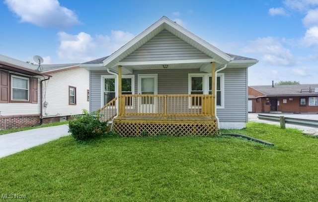 view of front of home featuring covered porch and a front yard