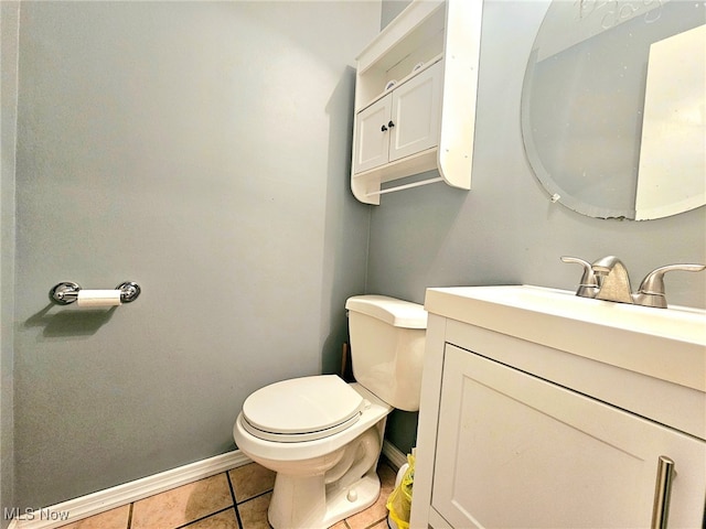 bathroom with tile patterned flooring, vanity, and toilet