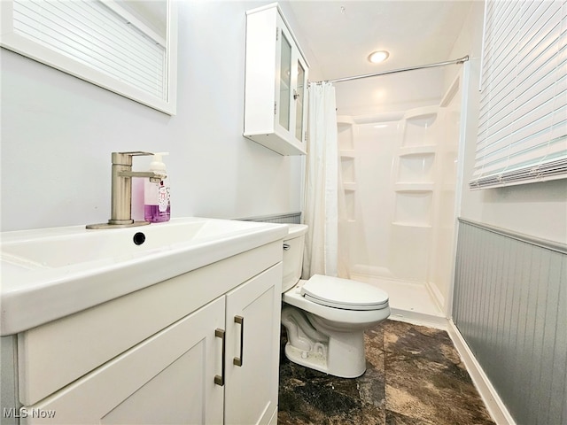 bathroom with tile patterned floors, curtained shower, vanity, and toilet