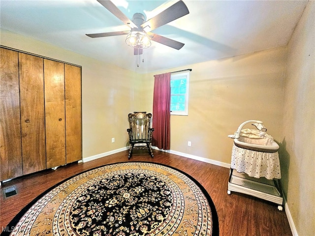 living area featuring dark hardwood / wood-style flooring and ceiling fan