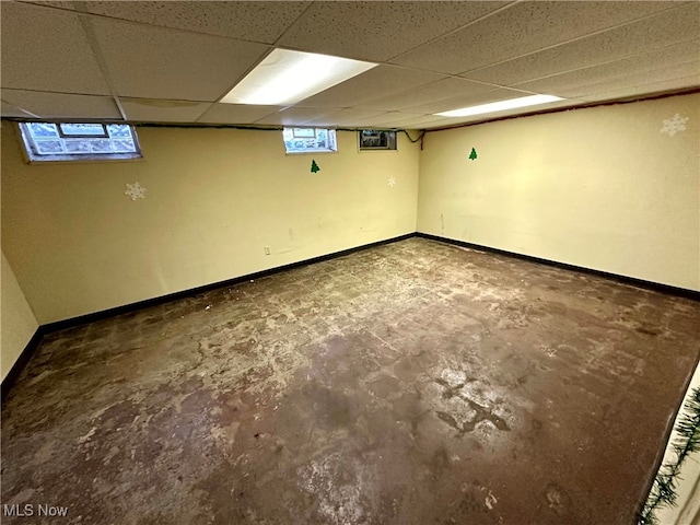 basement with a paneled ceiling