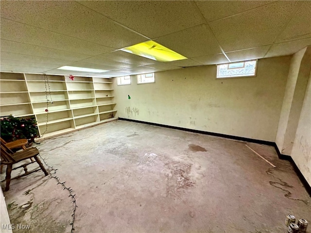 basement with plenty of natural light and a drop ceiling