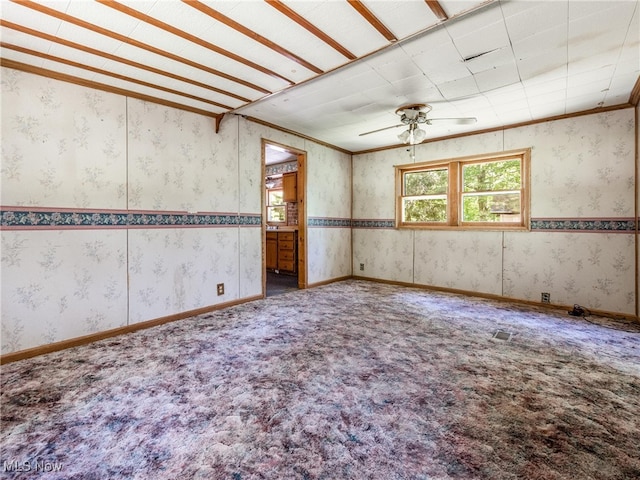 carpeted spare room featuring ceiling fan