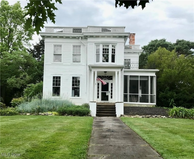 italianate-style house with a front yard