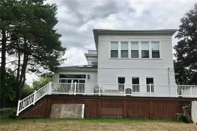 back of property featuring a deck