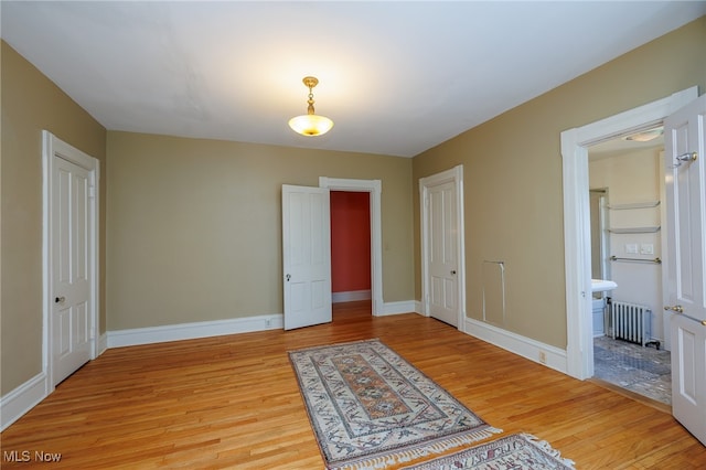 interior space with light hardwood / wood-style floors and radiator