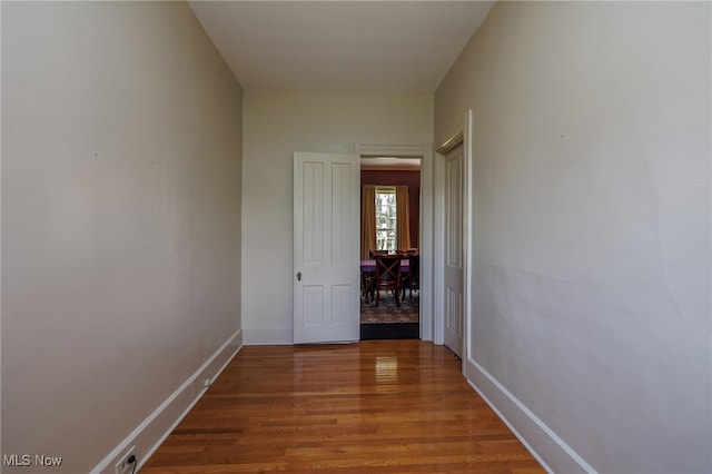 corridor with wood-type flooring