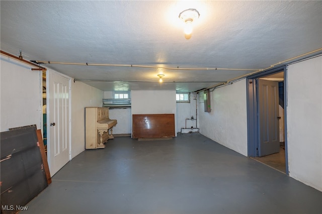 basement featuring a textured ceiling