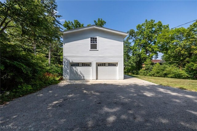 view of side of property with a garage