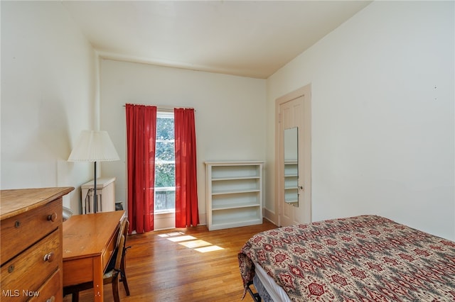 bedroom with hardwood / wood-style floors