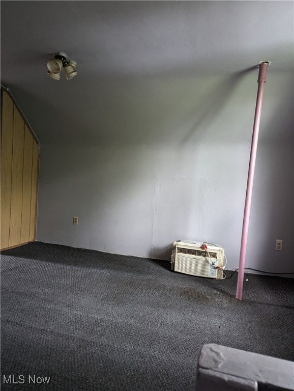 carpeted empty room with a wall unit AC