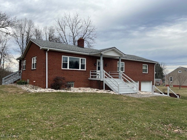 view of front of property with a front lawn and a garage