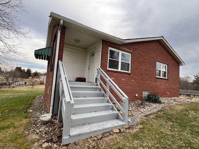 rear view of house featuring a lawn