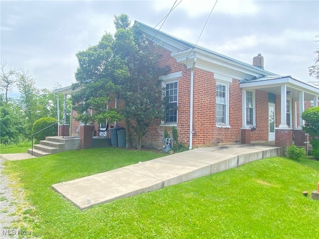 view of side of property with a yard