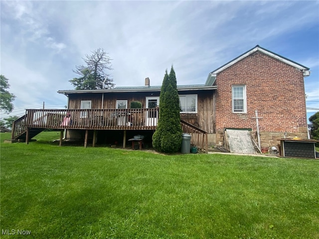 back of house with a lawn and a wooden deck