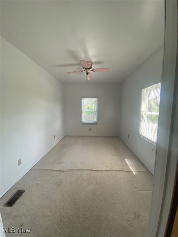 carpeted empty room featuring ceiling fan