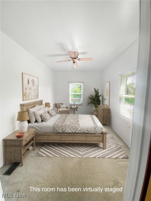 carpeted bedroom with ceiling fan