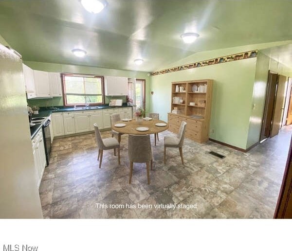 kitchen featuring white cabinets, sink, and stainless steel electric range