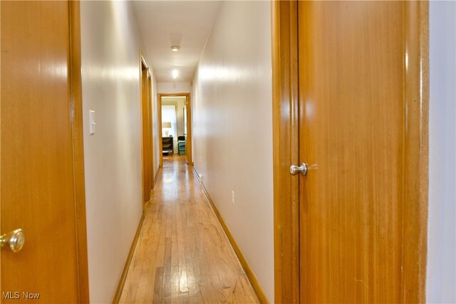 corridor with light hardwood / wood-style flooring