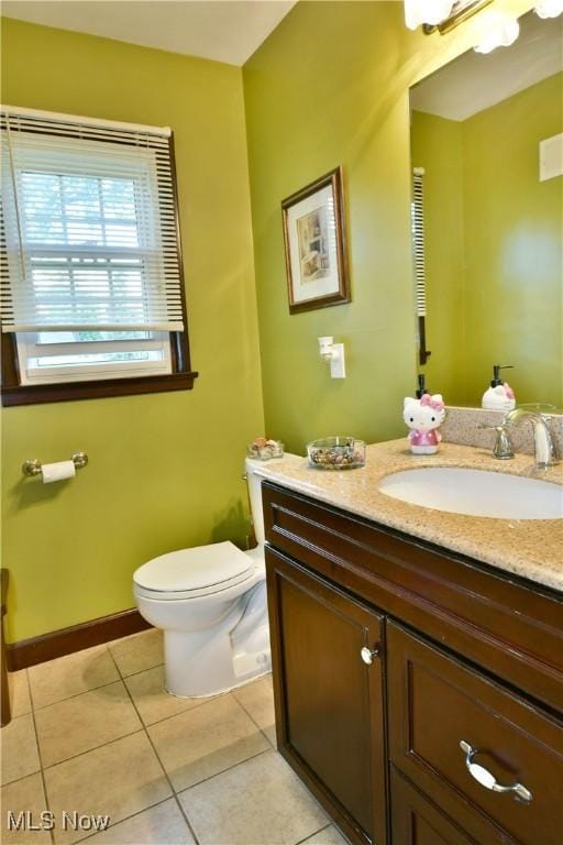 bathroom with visible vents, baseboards, toilet, tile patterned flooring, and vanity