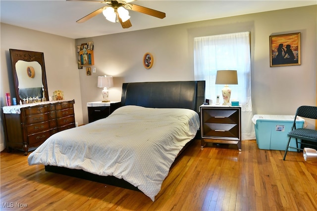 bedroom with ceiling fan and wood-type flooring