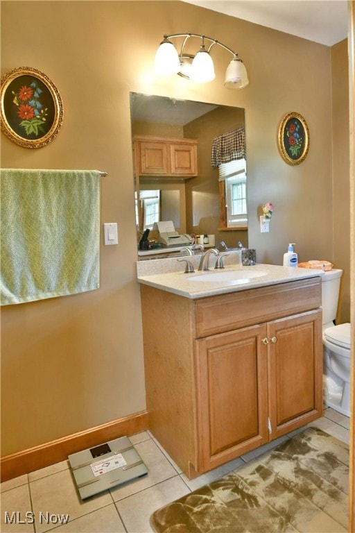 bathroom featuring tile patterned flooring, toilet, and vanity