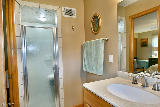 bathroom with vanity and a shower with shower door