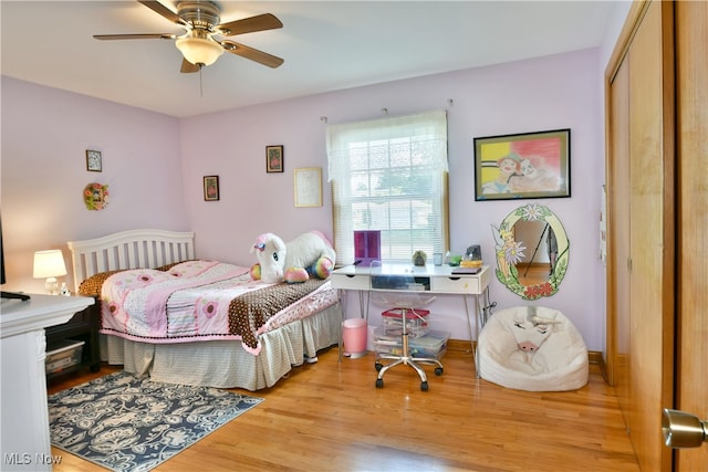 bedroom with ceiling fan, light wood-type flooring, and a closet