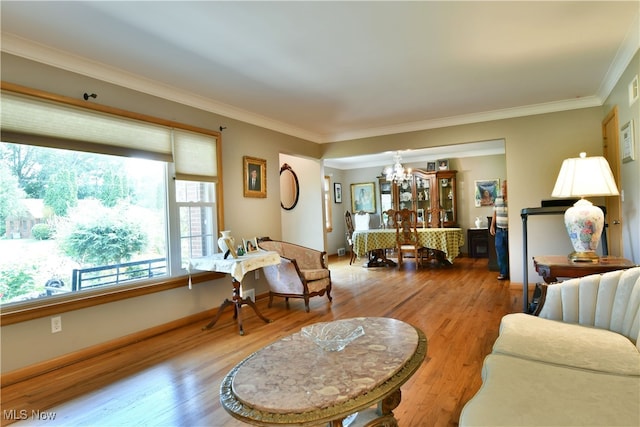 living room featuring crown molding, hardwood / wood-style floors, and a chandelier