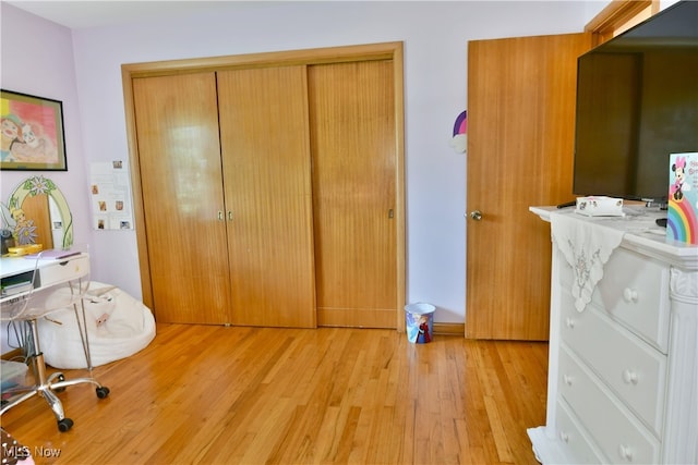 bedroom featuring a closet and light hardwood / wood-style floors