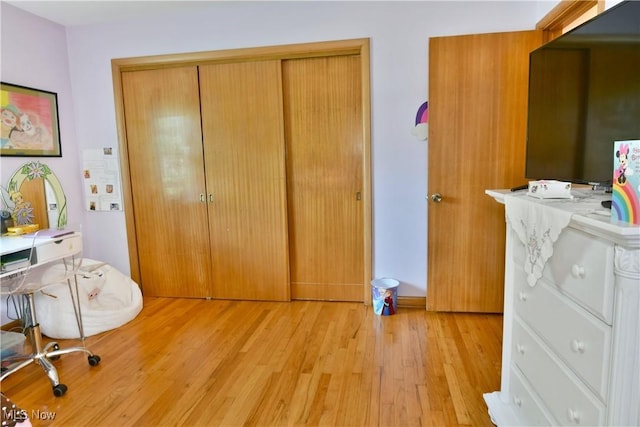 bedroom featuring light wood-type flooring and a closet