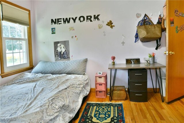 bedroom with wood-type flooring