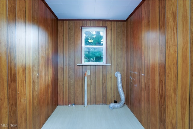 unfurnished room featuring wood walls