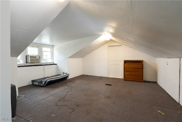 bonus room featuring carpet, vaulted ceiling, a textured ceiling, and cooling unit