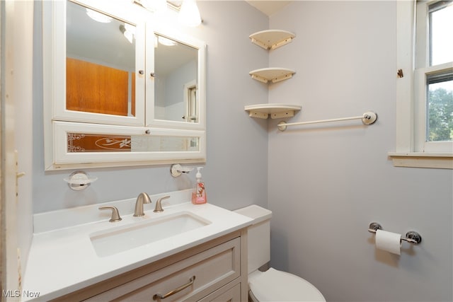 bathroom featuring toilet and vanity