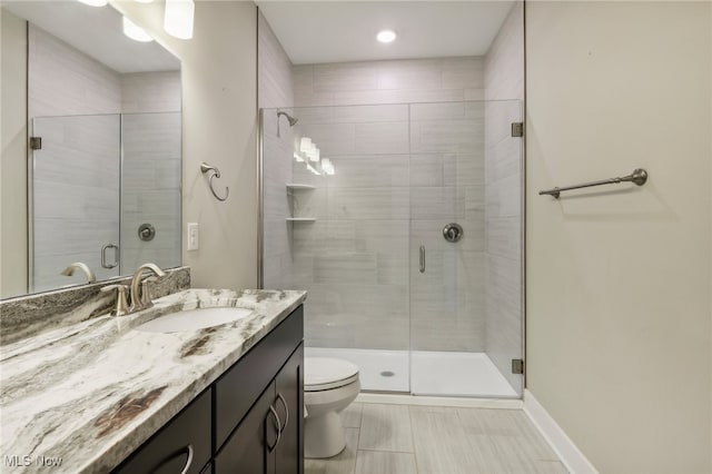 bathroom featuring an enclosed shower, toilet, vanity, and tile patterned floors