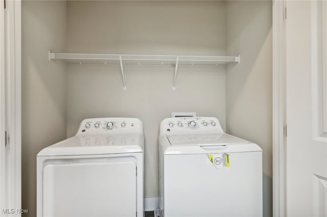 clothes washing area with separate washer and dryer