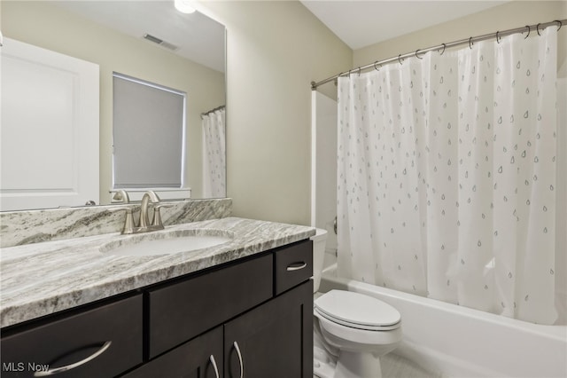 full bathroom featuring shower / bath combination with curtain, vanity, and toilet