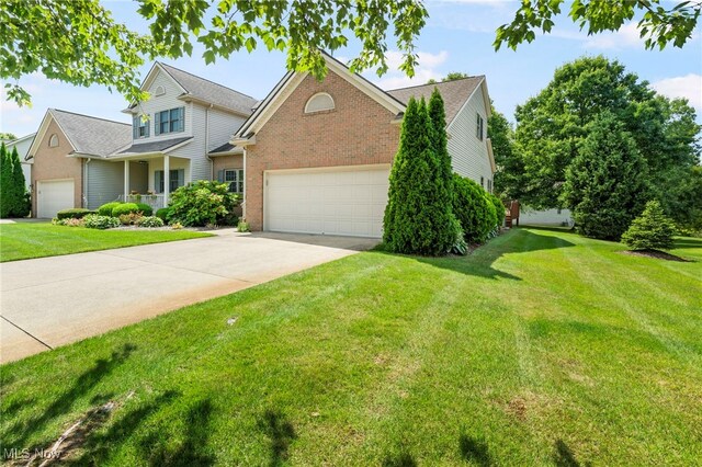 view of front of home featuring a front lawn and a garage