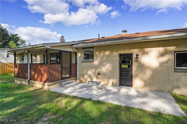 rear view of house with a patio and a yard